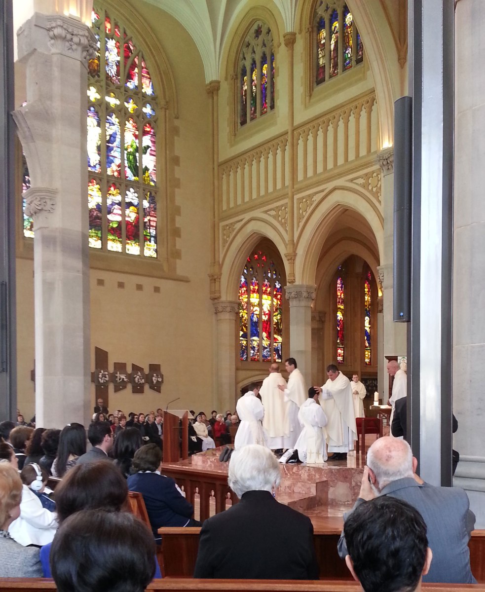 Fr Peter Meo praying over Christian Irdi